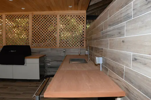Ванная: EFTA00002814 - Wooden countertop with sink and grill under lattice wall