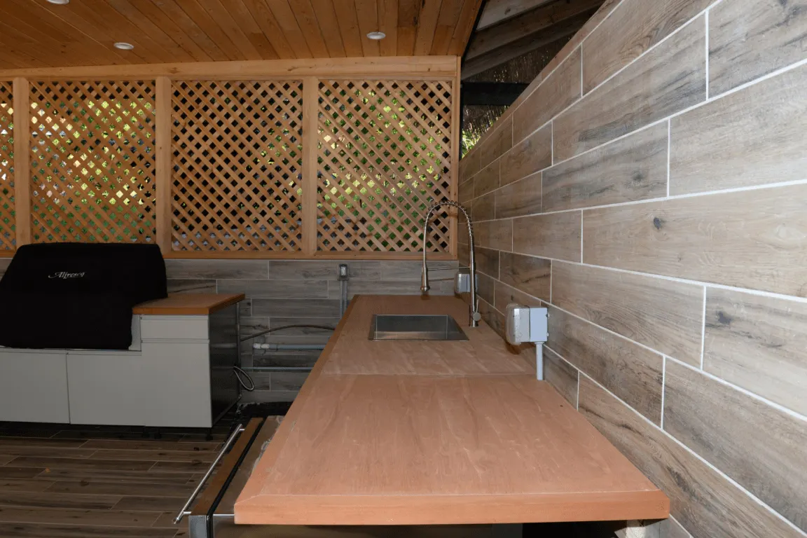Salle de bains: EFTA00002814 - Wooden countertop with sink and grill under lattice wall