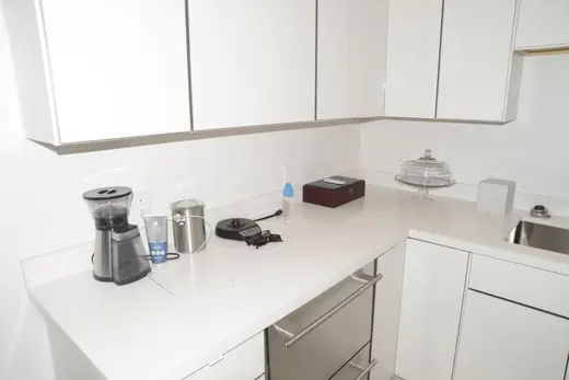 Ванная: EFTA00002874-Pool-House - Modern white kitchen with stainless steel sink coffee maker and 