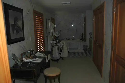 Ванная: GX-283 - Marble-walled room with wooden shutters vanity medical equipment and a checkered 