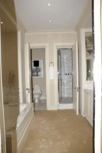 Badezimmer: EFTA00000613 - Luxurious bathroom with marble countertops a bathtub a shower and a toilet 