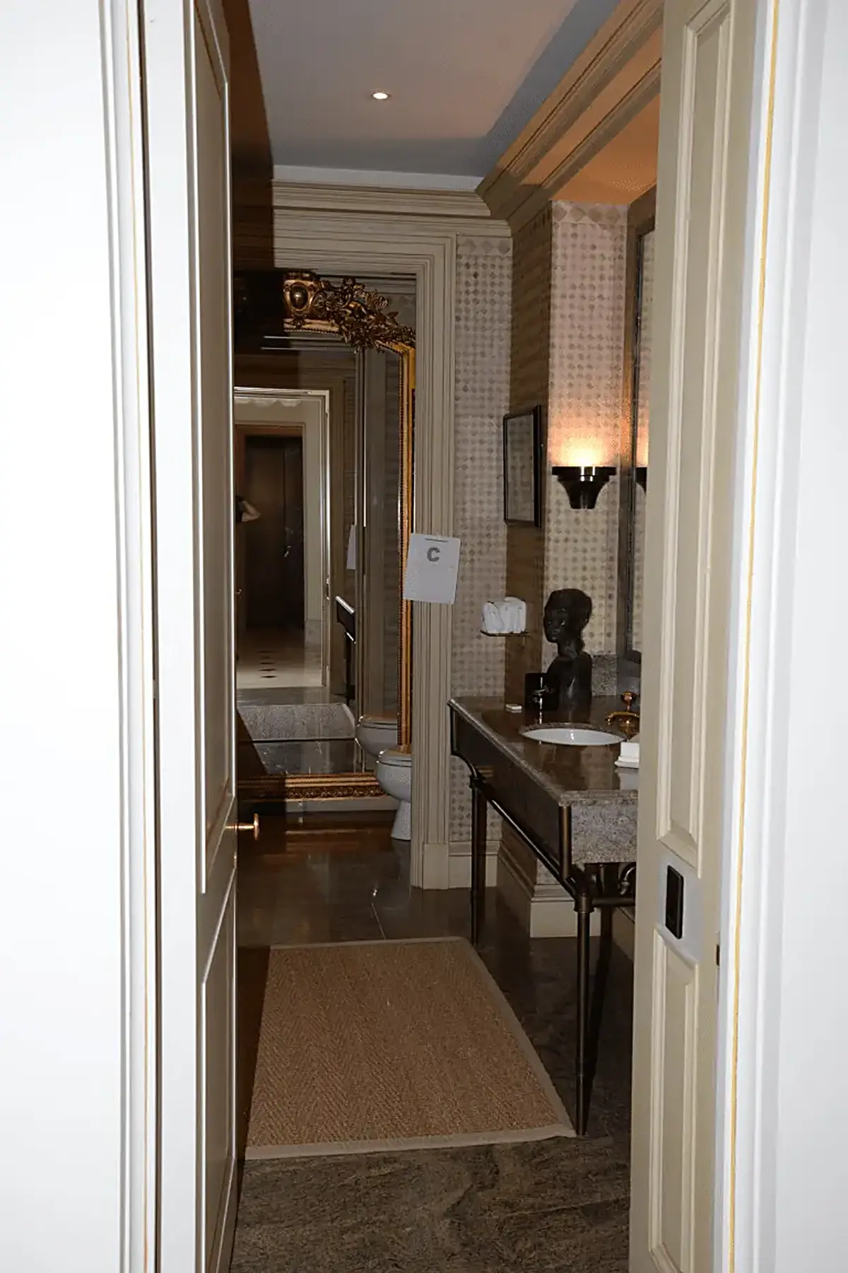 Baño: EFTA00000903 - Luxurious bathroom hallway with marble flooring ornate mirrors and elegant 