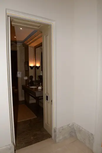 Badezimmer: EFTA00000911 - Doorway leads into a luxurious bathroom featuring a marble countertop elega