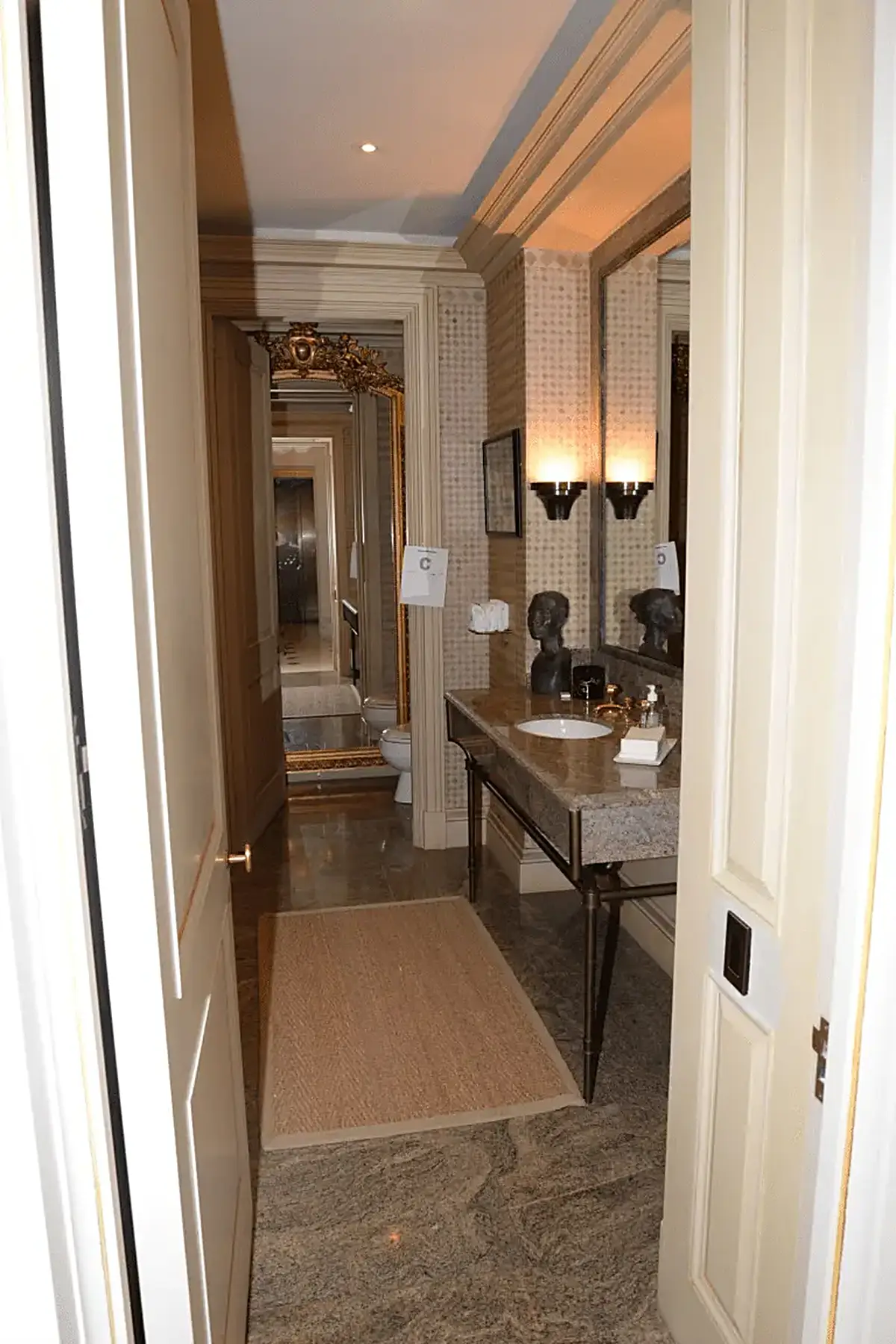 Baño: EFTA00001454 - Luxurious bathroom hallway with marble flooring a granite countertop ornate