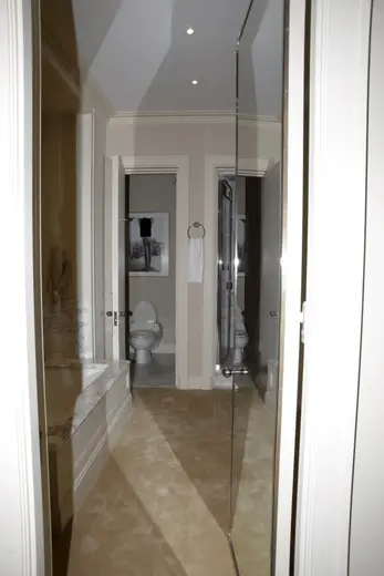 Badezimmer: EFTA00000272 - Modern bathroom viewed through an open doorway featuring a marble counterto