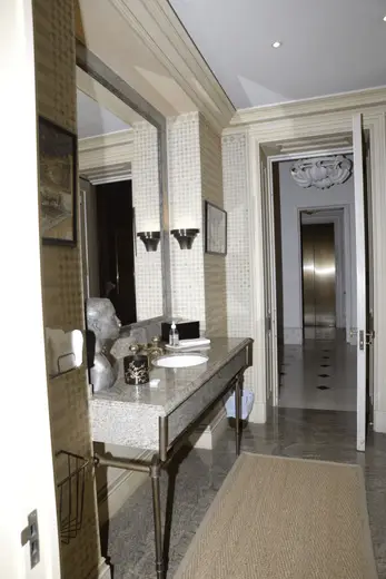 Badezimmer: EFTA00000805 - Elegant bathroom with marble countertop ornate mirror and patterned wallpap
