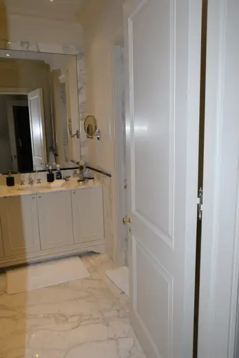 Badezimmer: EFTA00001117 - Spacious bathroom featuring white marble floors a large vanity with a sink 