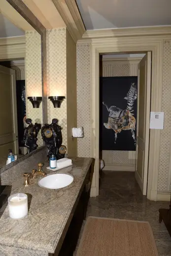 Badezimmer: EFTA00000936 - Luxurious bathroom featuring a granite countertop ornate fixtures and a str