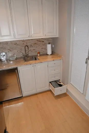 Badezimmer: EFTA00001370 - Kitchen nook with white cabinets granite countertop stainless steel sink an