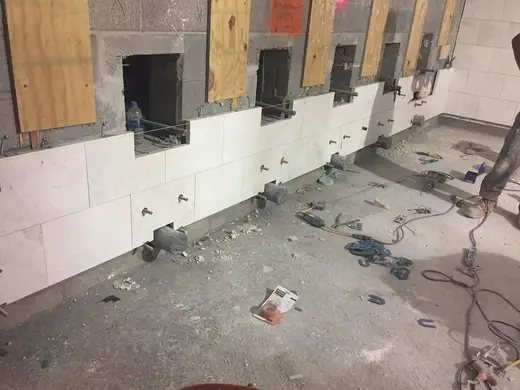 Badezimmer: Installation of marble finishes in the women's bathroom located in the future LIRR passeng