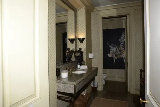 Ванная: EFTA00000059 - Elegant bathroom features a marble countertop ornate mirror and patterned w