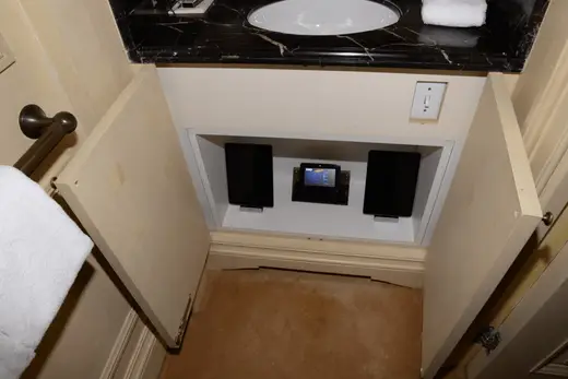 Ванная: EFTA00001408 - Bathroom vanity with a black marble countertop white sink and built-in spea