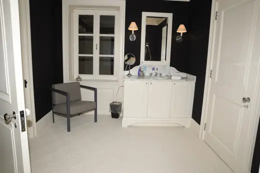 Ванная: EFTA00000586 - Modern bathroom with black walls white cabinetry a marble countertop and a 