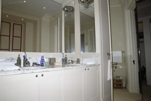 Ванная: EFTA00000615 - Spacious bathroom featuring a double sink with marble countertop white cabi