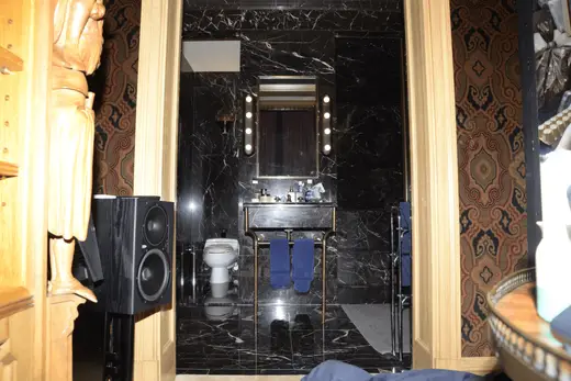 Ванная: EFTA00000654 - Luxurious bathroom with black marble walls a vanity mirror with lights and 
