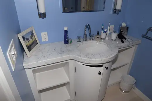 Ванная: EFTA00001791 - Bathroom with blue walls white vanity marble countertop and a sink featurin