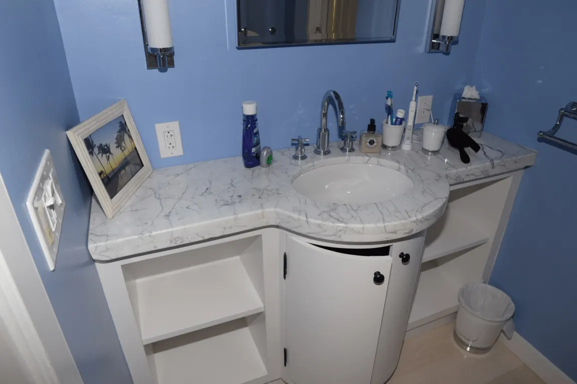 Badezimmer: EFTA00001791 - Bathroom with blue walls white vanity marble countertop and a sink featurin