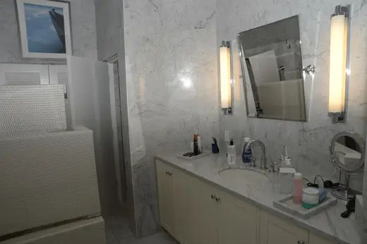 Ванная: EFTA00002890-Pool-House - Elegant marble bathroom with white cabinetry sink and modern lig