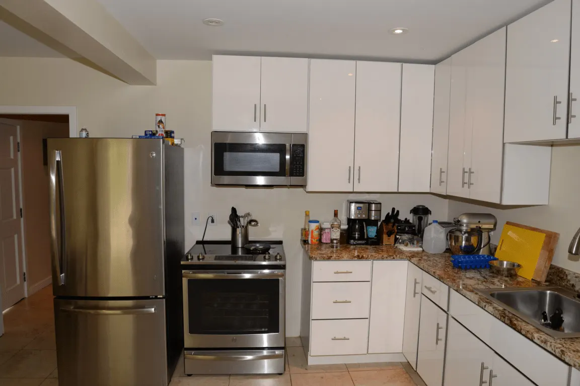Baño: EFTA00002129 - Modern kitchen with stainless steel appliances white cabinets granite count