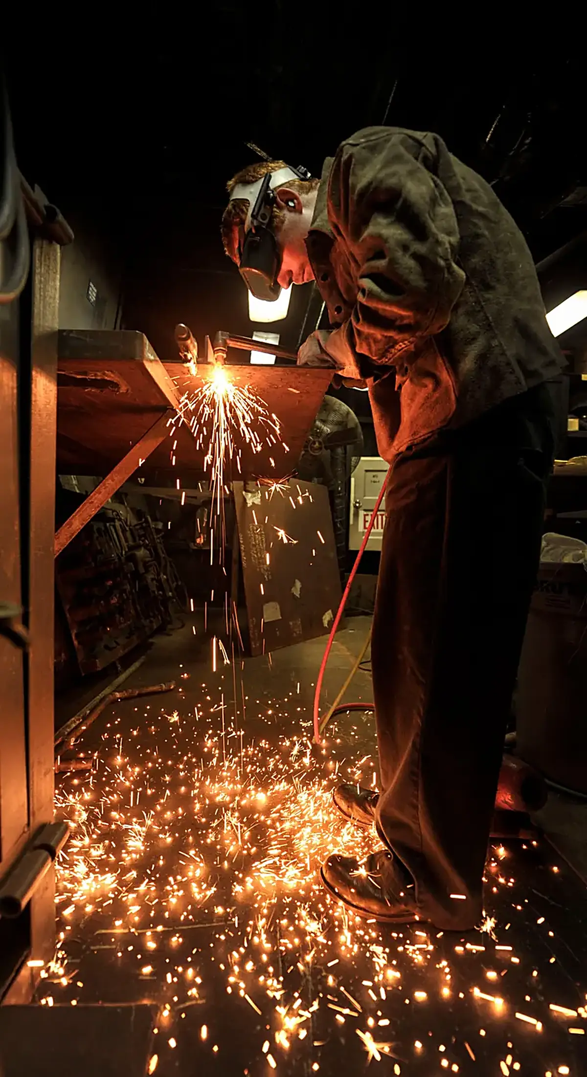 Kitchen: A U.S. Navy Hull Maintenance Technician 3rd Class Robert Frey fabricates a steel counterto