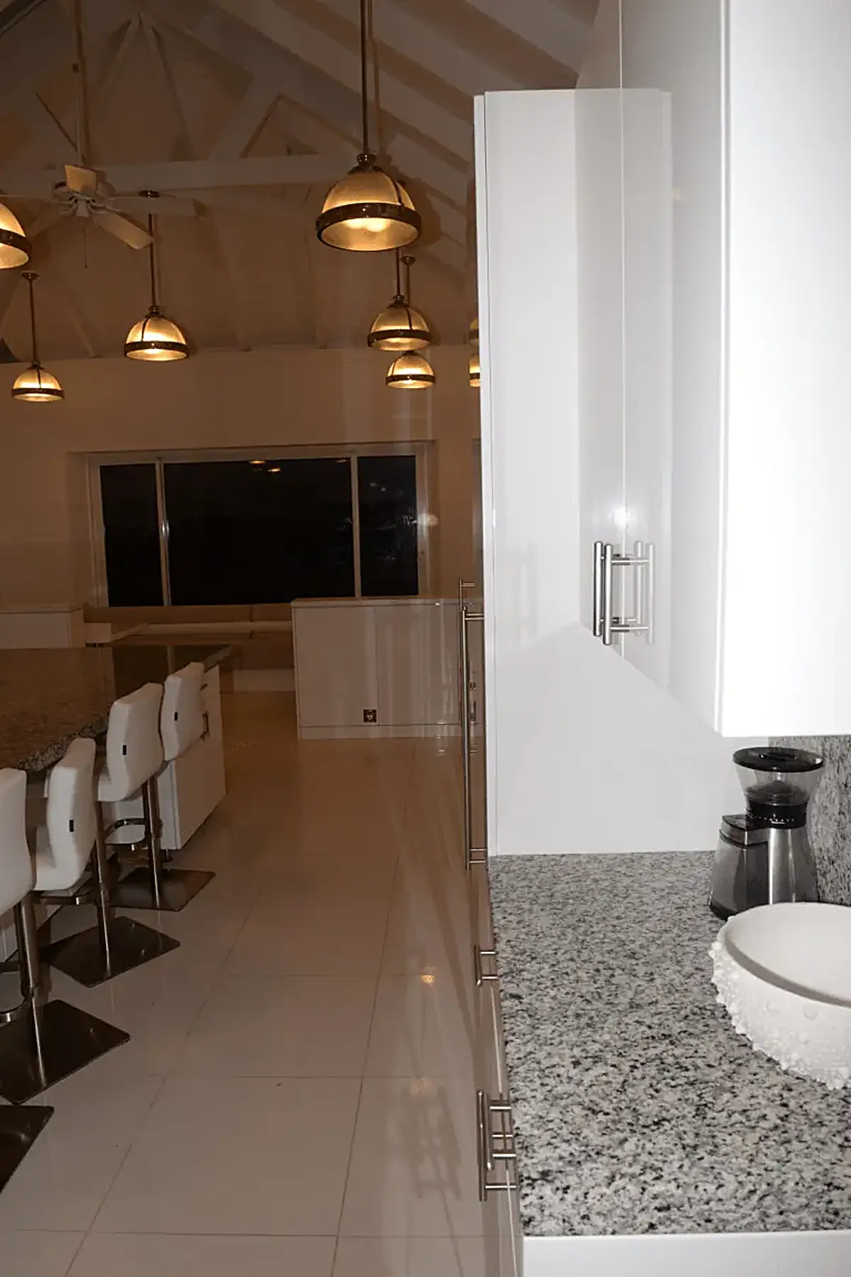 Cocina: EFTA00002062 - Modern kitchen with white cabinets granite countertop and pendant lights un