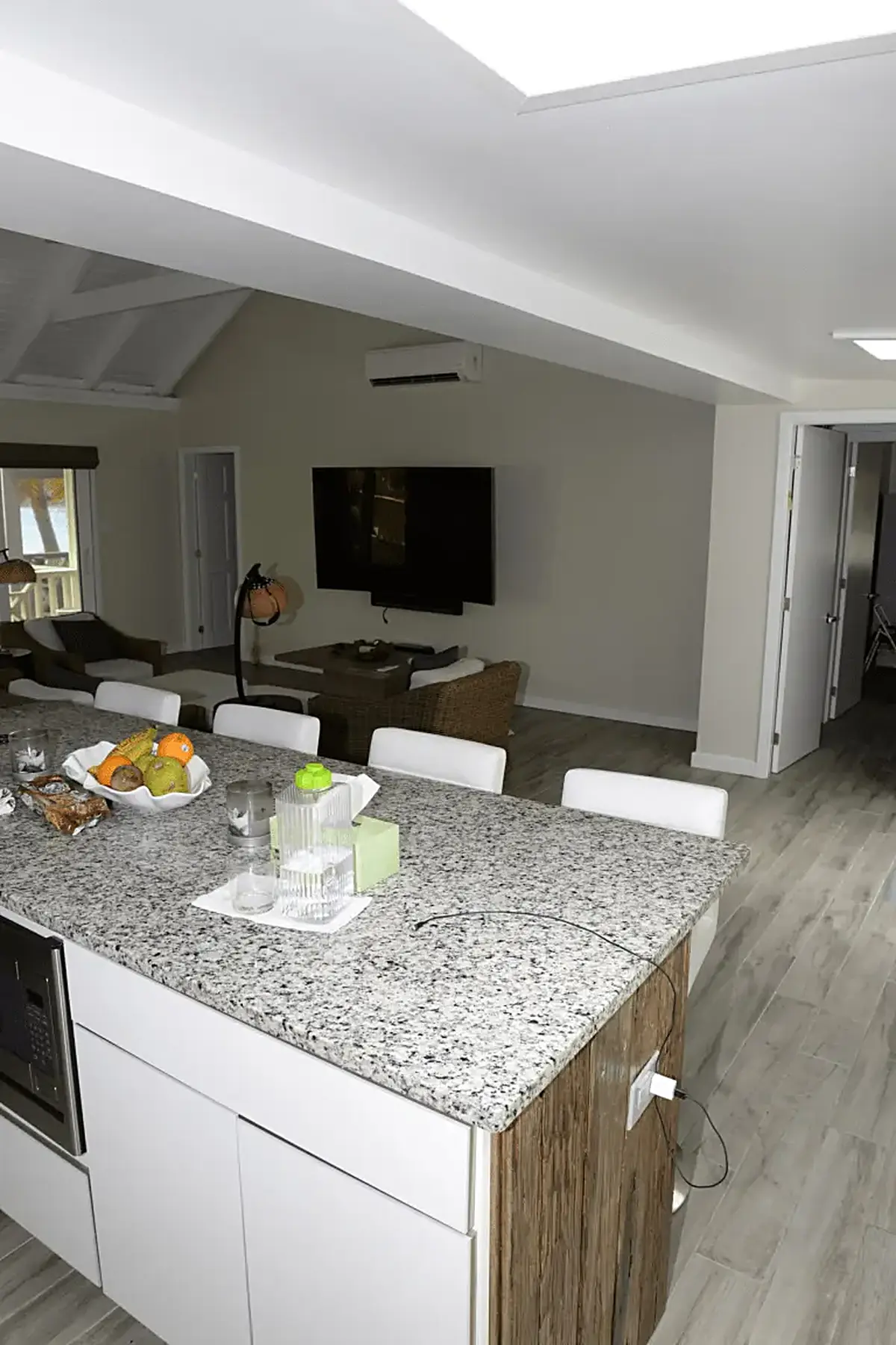 Cuisine: EFTA00002083 - Modern kitchen island with granite countertop white bar stools and fresh fr