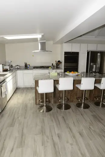 Kitchen: EFTA00002080 - Modern kitchen with white cabinets granite countertops stainless steel appl