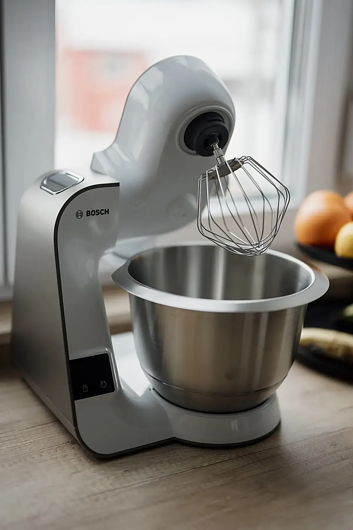 Cuisine: Kitchen mixer sits on countertop near fruit bowl in bright kitchen