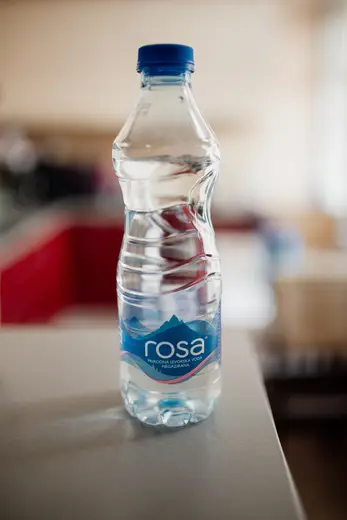 Kitchen: Clear bottle of natural mineral water placed on a countertop in a bright kitchen setting