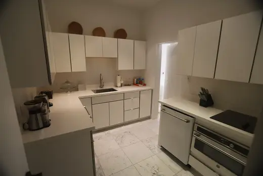 Kitchen: USVI IMG 5429 - Modern white kitchen with sleek cabinets marble floor and stainless steel 