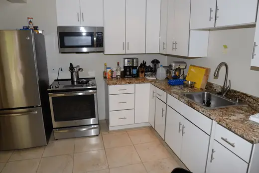 Kitchen: EFTA00002128 - Modern kitchen with stainless steel appliances granite countertops and whit