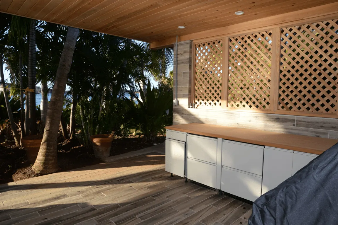 Kitchen: EFTA00002810 - Wooden lattice wall and countertop white cabinets wooden floor palm trees s
